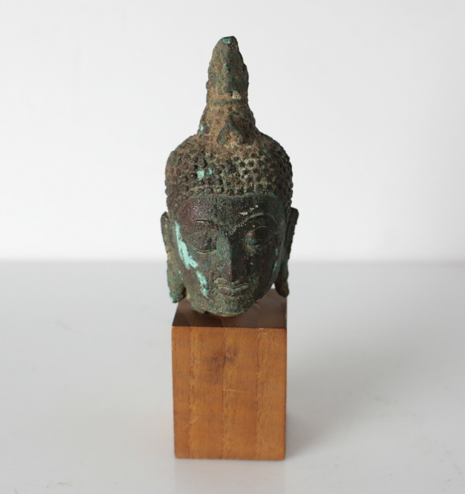 Antique Indo Asian Thai Buddhist bronze Head fragment, mounted on wood plinth